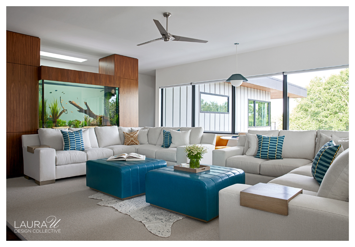 Family room with built-in aquarium framed by walnut millwork and surrounded by modern seating.