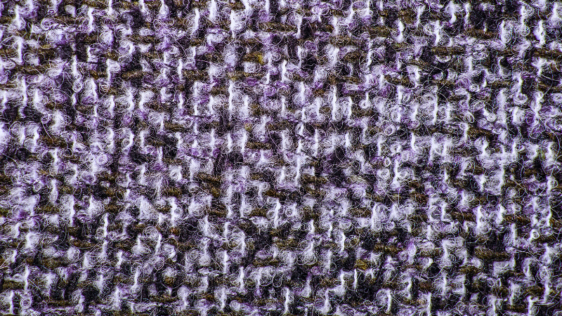 A close up image of a purple and white twill fabric