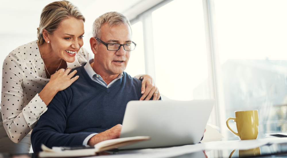 Happpy couple looking at laptop 