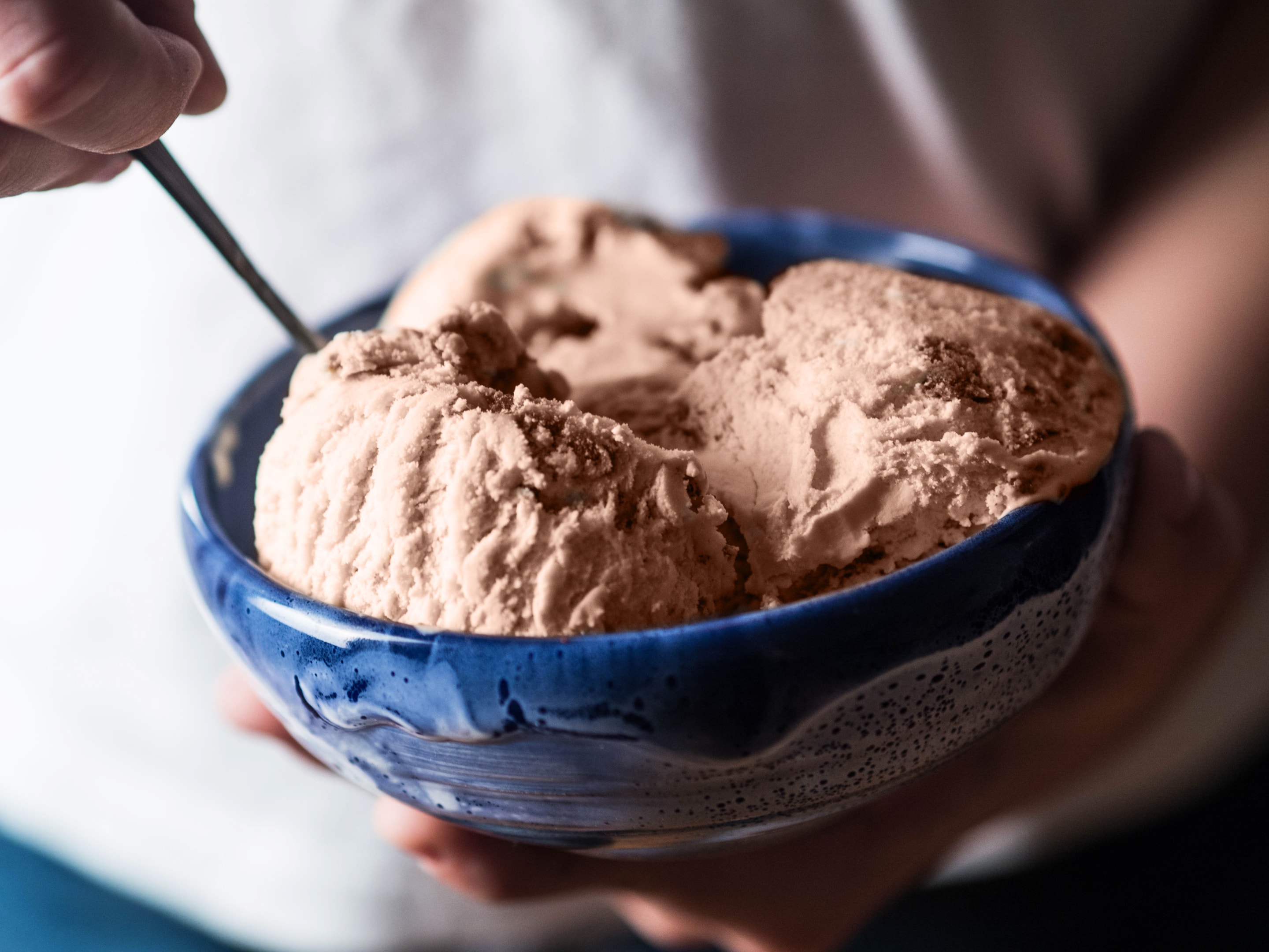 Woman enjoying keto ice cream bar after workout, demonstrating how protein ice cream fits into keto diet and active lifestyle
