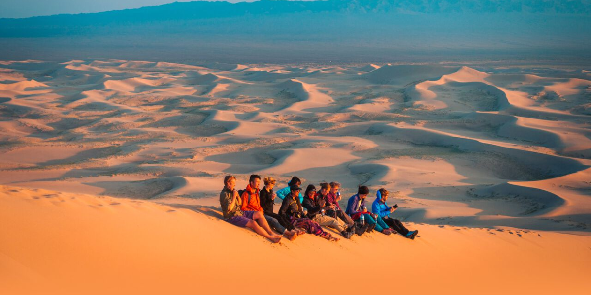 Tourists sitting on Gobi Desert