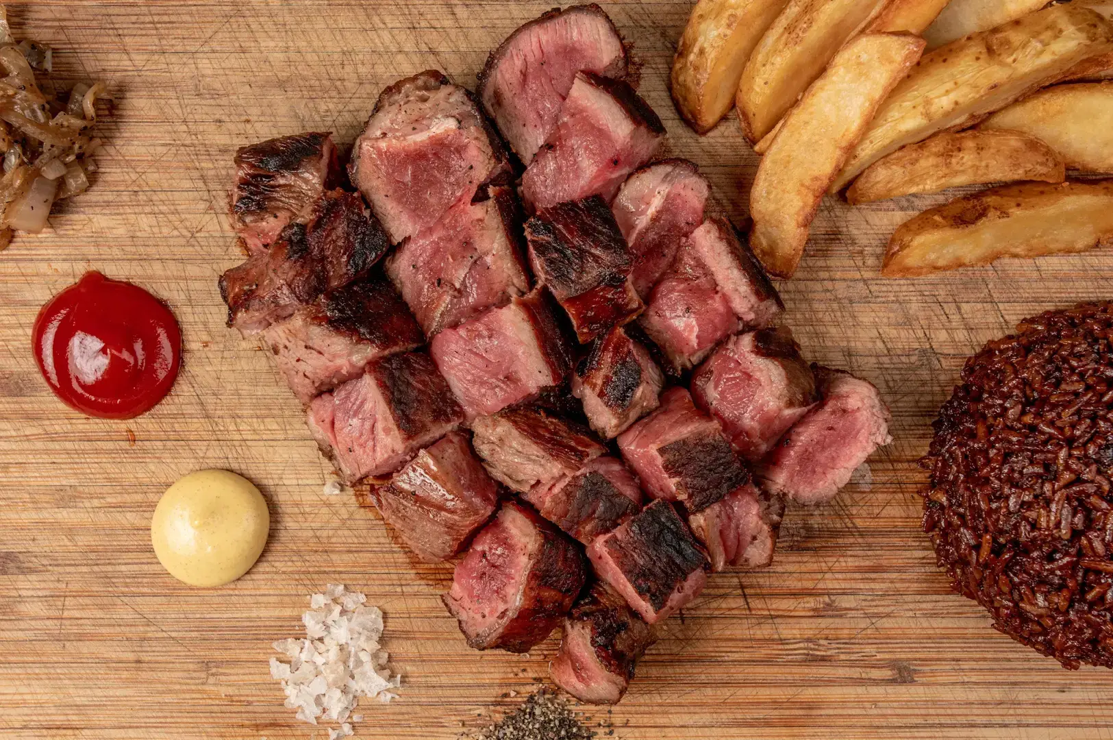 Singapore seafood restaurant dish featuring grilled steak with fries and rice