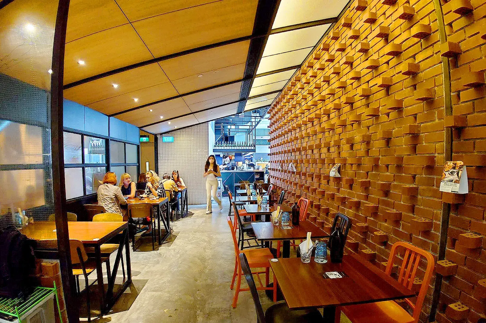 Tanuki Raw Japanese restaurant entrance near Somerset MRT in Singapore with neon signage and dining area
