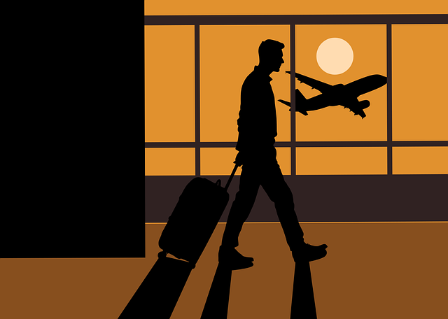 A silhouette of a man walking in the airport as a plane is taking off, representing travel endeavours.