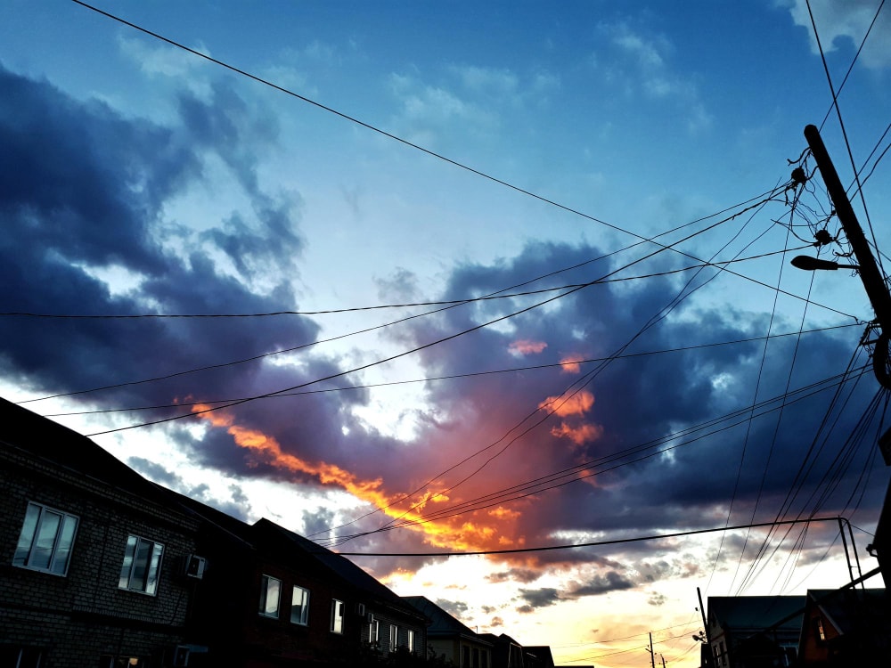 Low angle view of downed power lines creating a business disruption and causing potential threats.