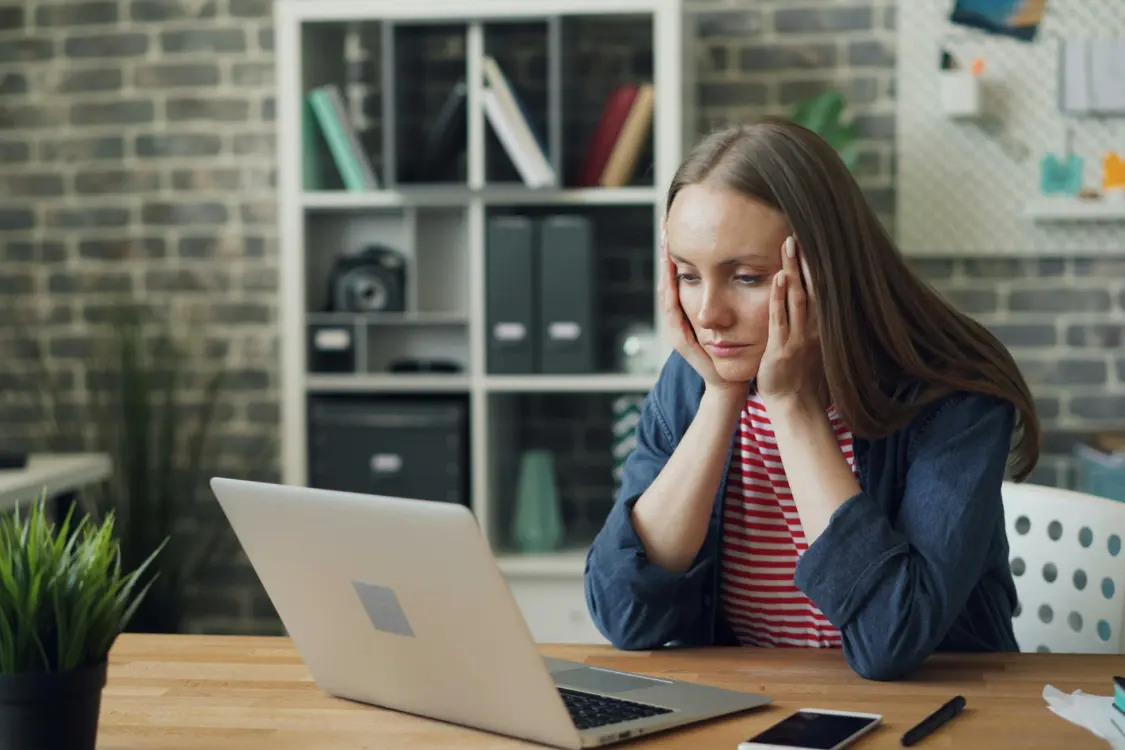 Concerned business owner reacting to vague valuation advice from an unprepared broker in a cluttered office.