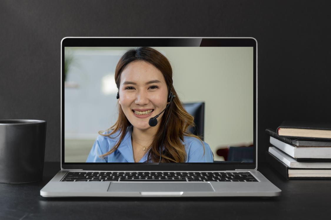 Filipino woman smiling on a video call interview on laptop