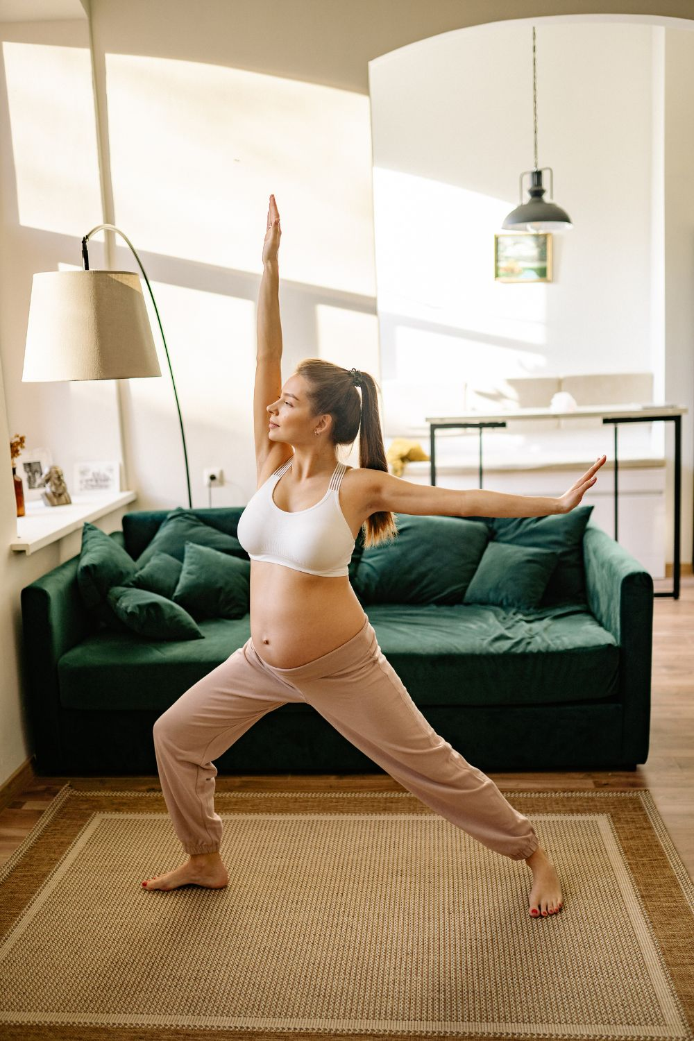 Pregnant woman doing yoga in the living room - A Diastasis recti exercise program is a great way to prevent and heal diastasis recti