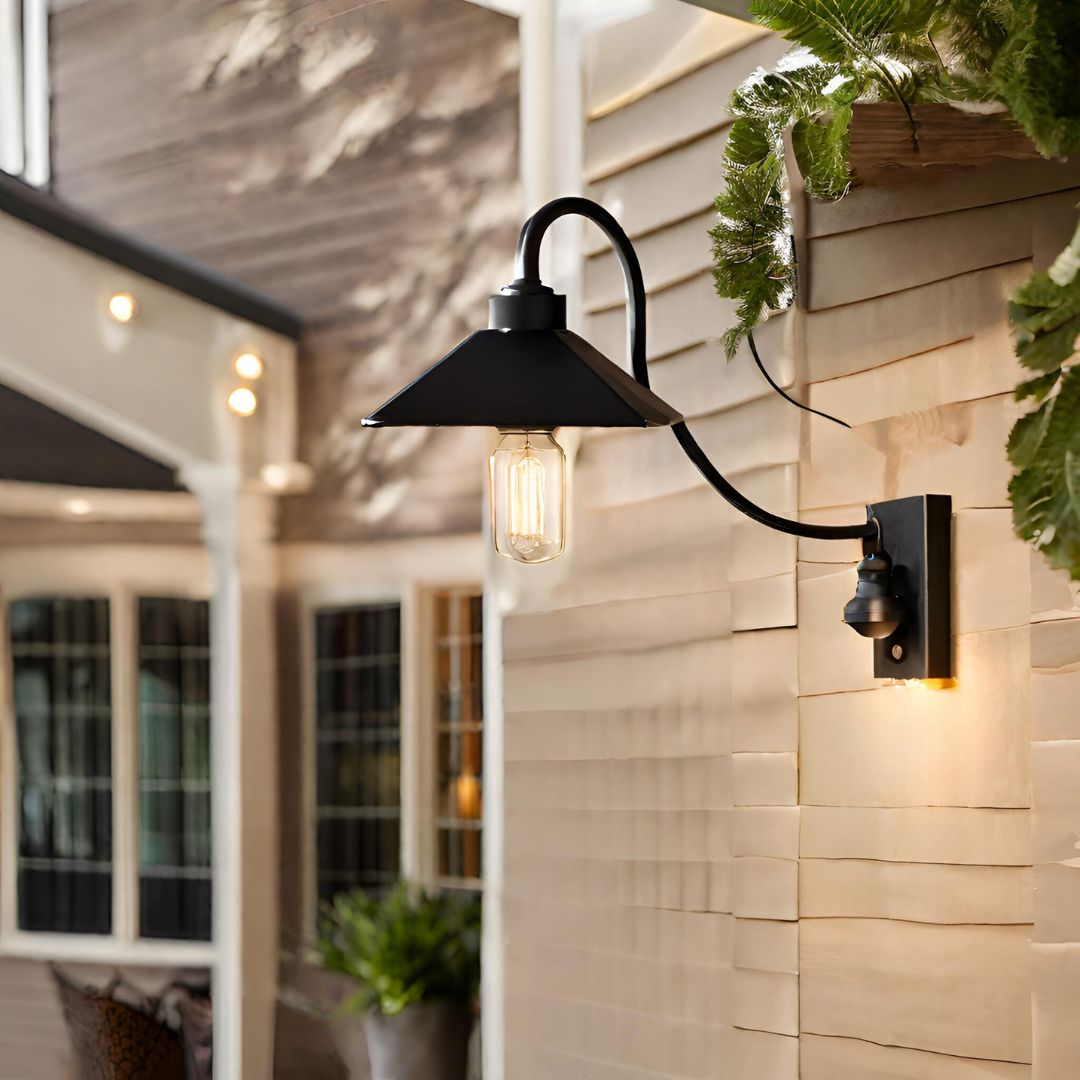 A cantilever design outdoor wall light placed on a wall with a warm glow.