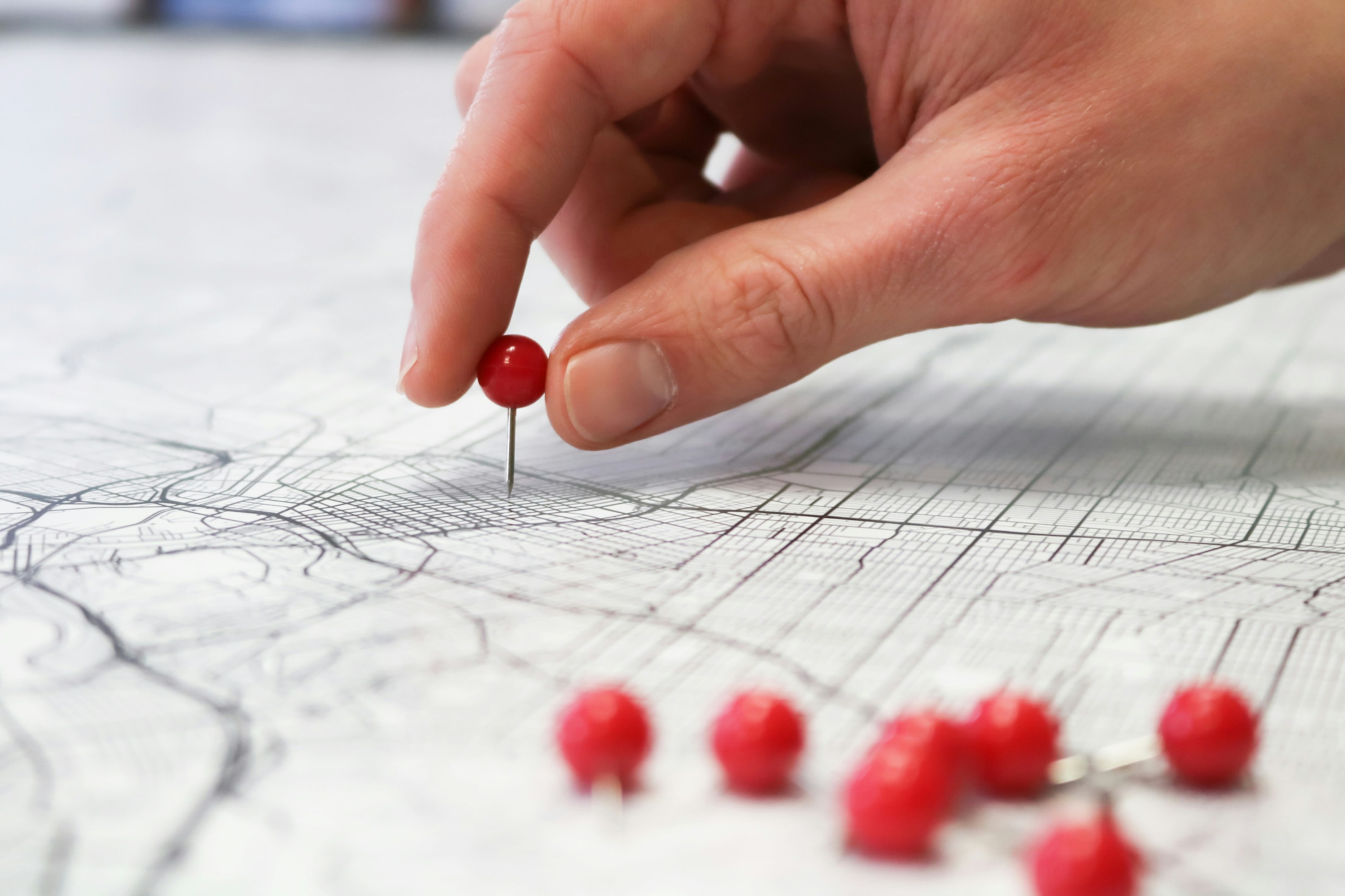 Real estate investor placing pins on map of where to find probate properties. 
