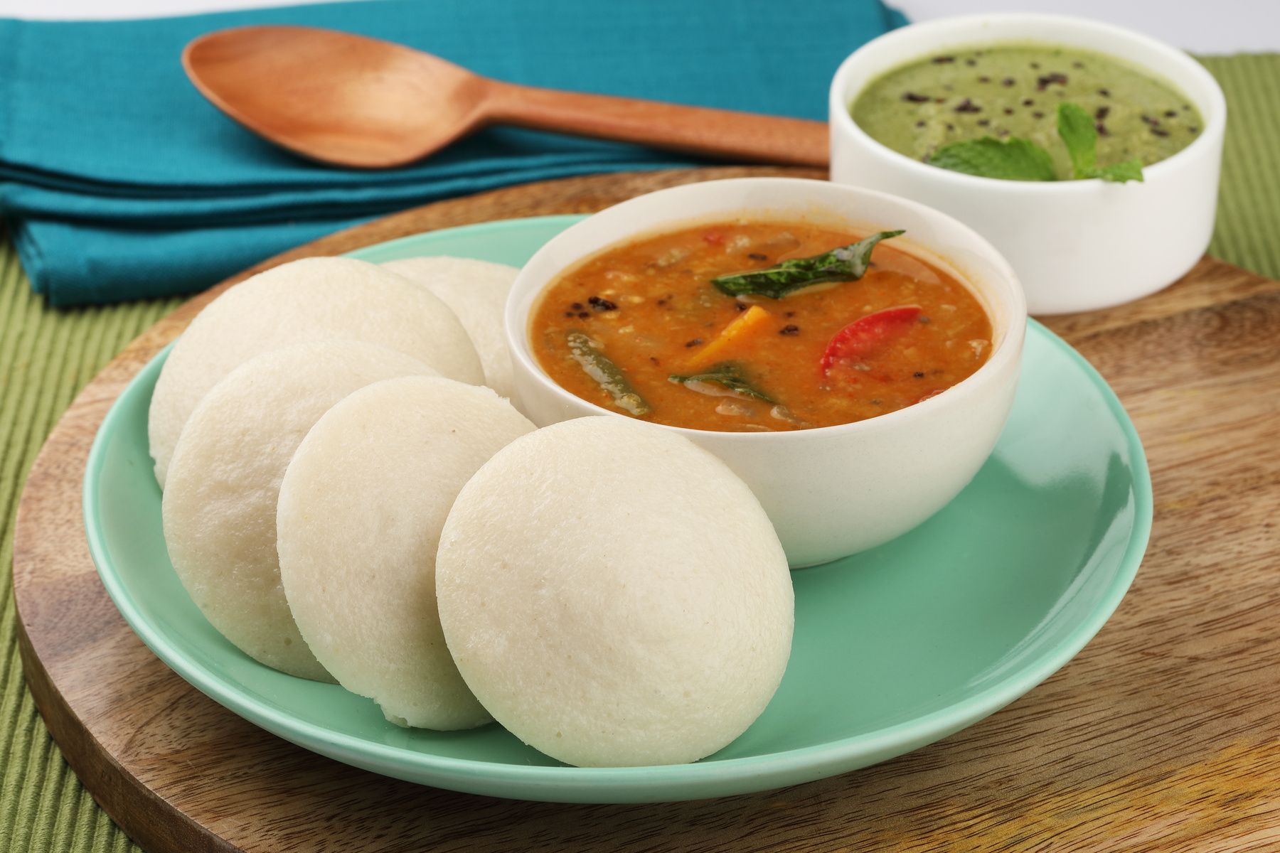 Idli sambhar - traditional South Indian dish served on a plate with vibrant, flavorful sambhar gravy.