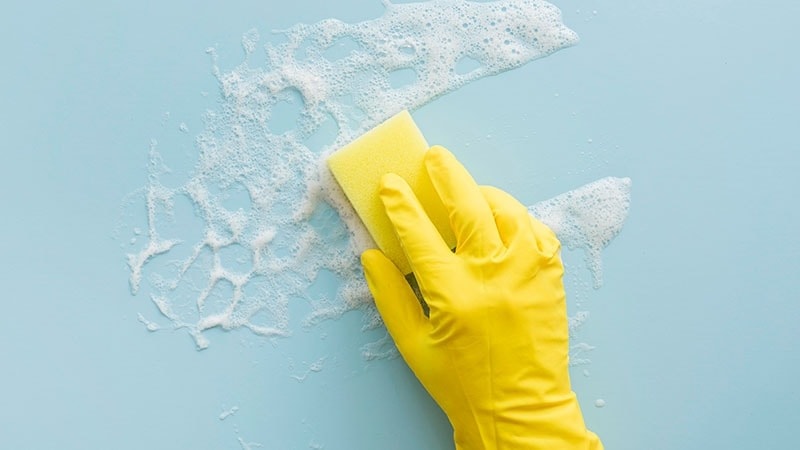 cleaning blue with soap and a sponge