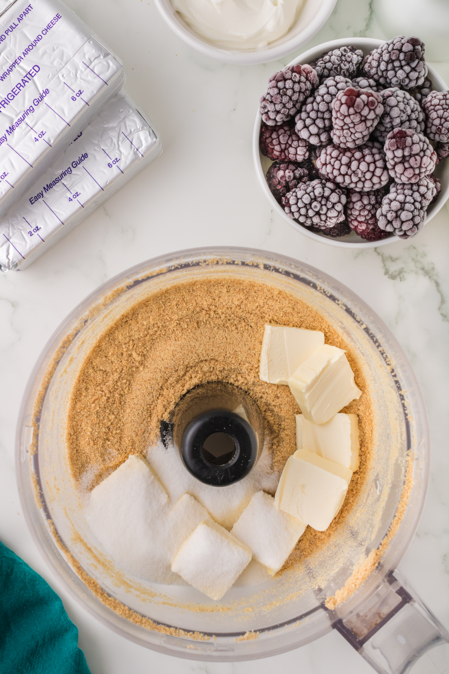 butter and granulated sugar added to graham cracker crumbs in food processor