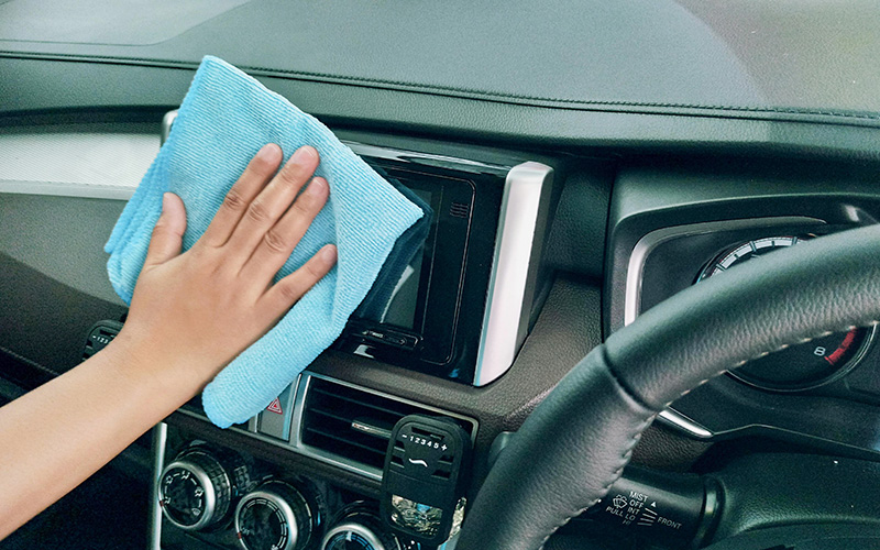 Women Using Microfiber Cloth to Clean Car Interior