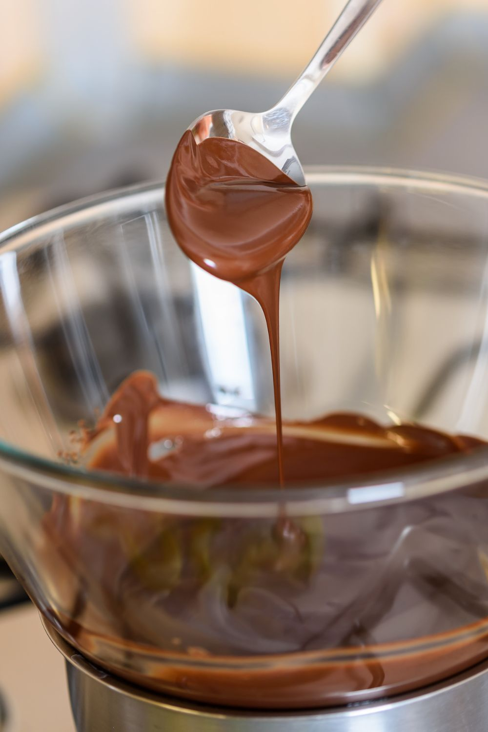 chocolate melted in a double boiler with a spoon dipped in it