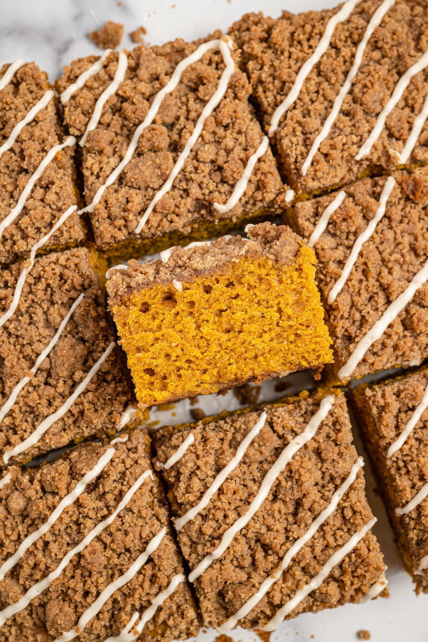 squares of pumpkin spice coffee cake with crumb topping one turned on its side