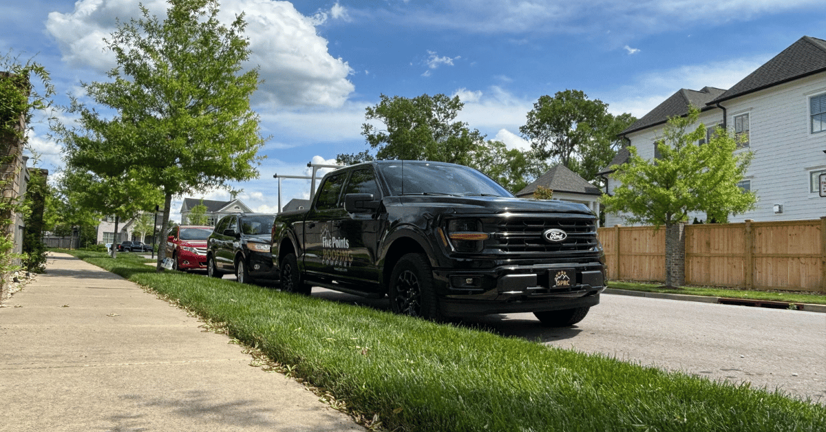 Branded Five Points Roofing truck parked in a local neighborhood, representing the company's presence and commitment to the community.