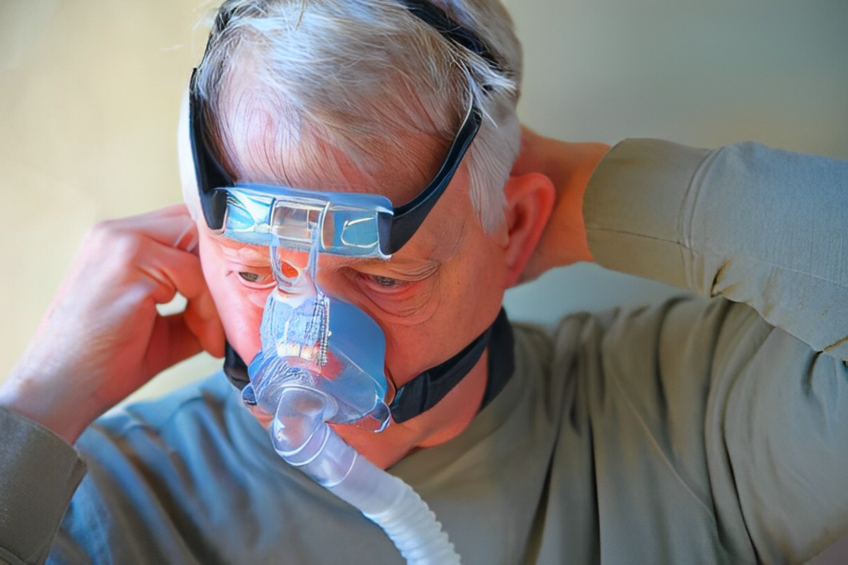 A photo of an elderly man wearing his CPAP headgears 