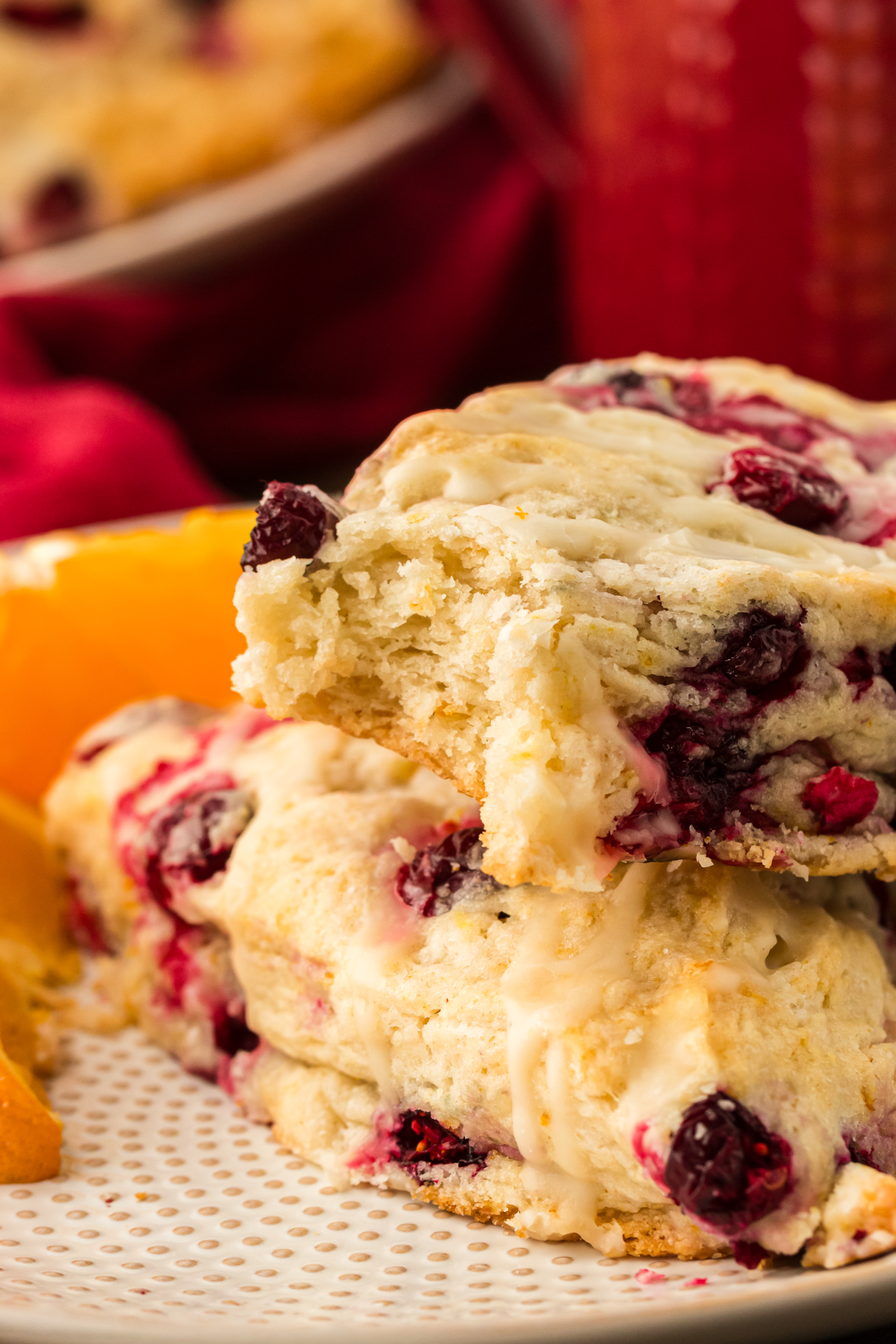 two cranberry orange scones stacked on top of each other