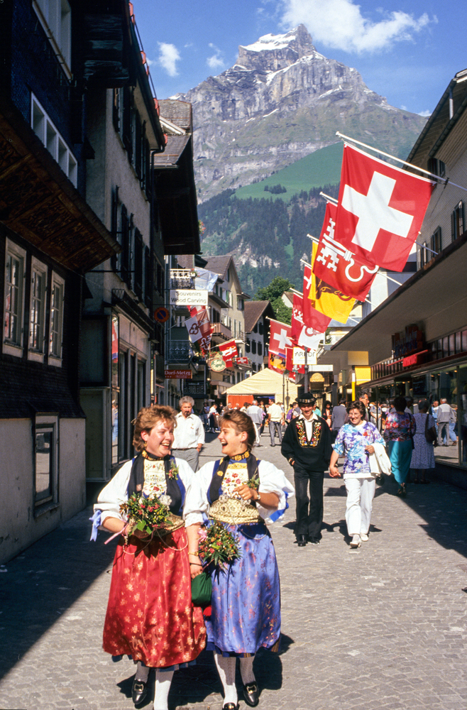 Mountains and parade with Swiss flags.