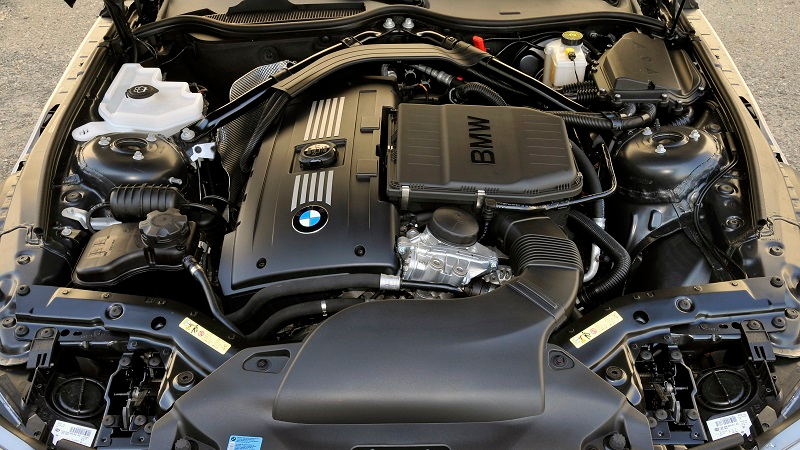 A BMW N54 engine with fuel injectors, high pressure fuel pump, and valve covers