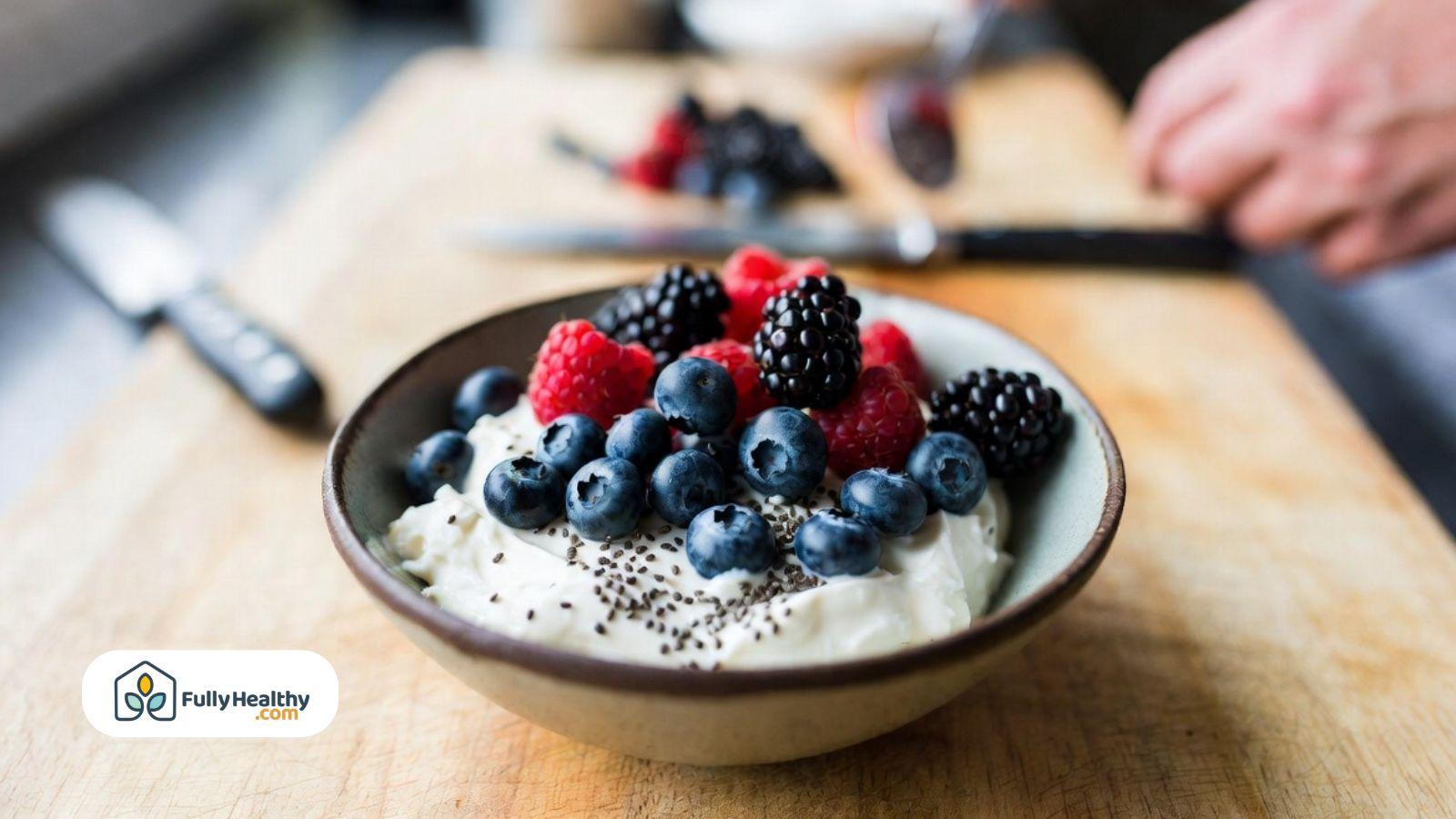 Bowl of yogurt topped with blueberries, blackberries, and chia seeds.