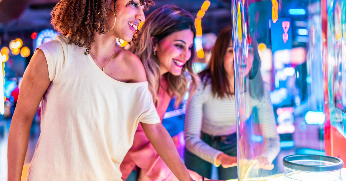 Guests enjoying boardwalk arcade games near Gardens Plaza Ocean City NJ, highlighting family-friendly attractions and entertainment.