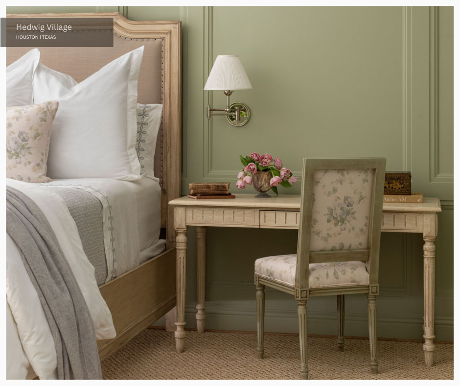 a feminine desk and bed in a pale green bedroom