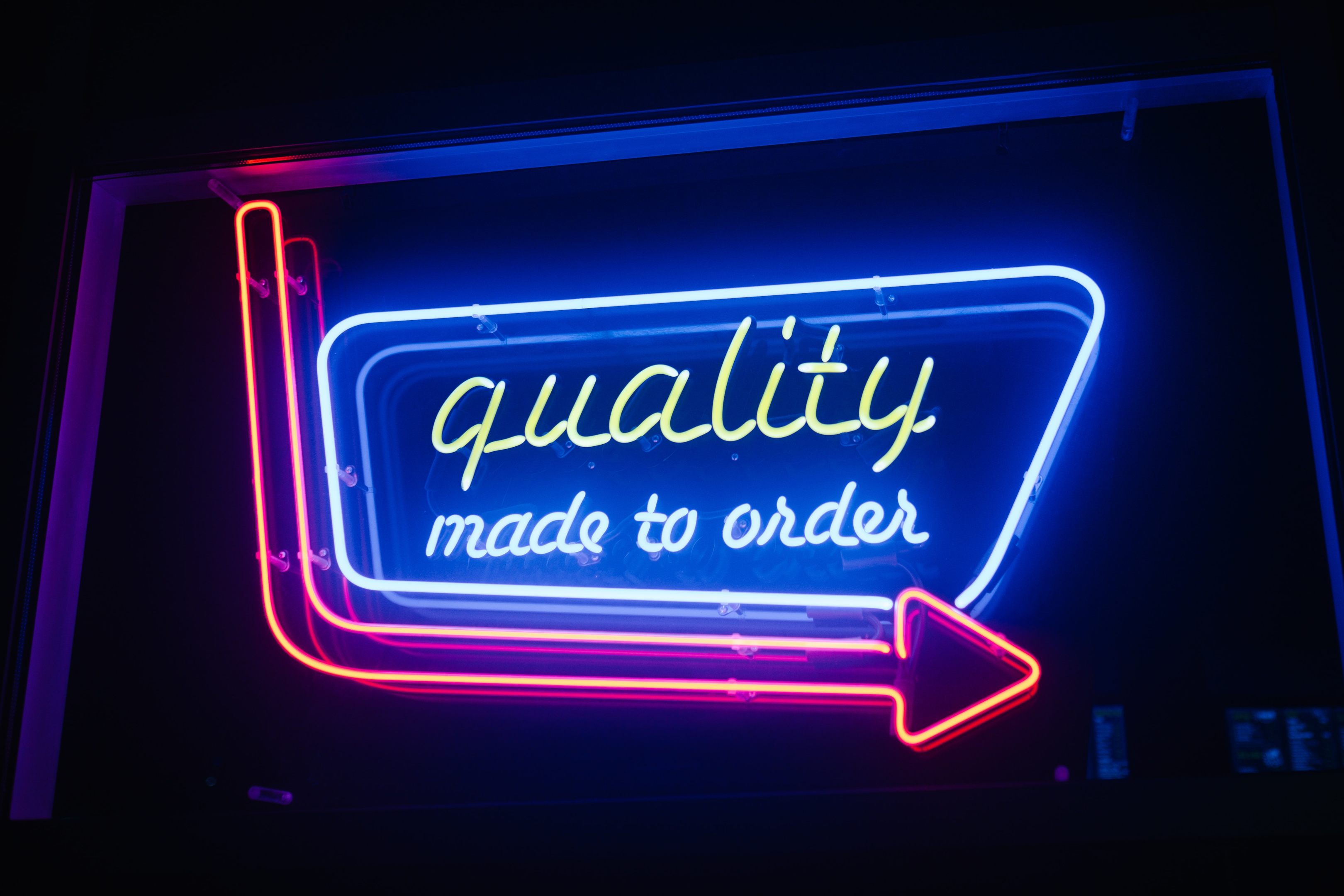 A neon sign that says quality made to order. Quality of service should not be lost when searching for lower car shipping costs. 