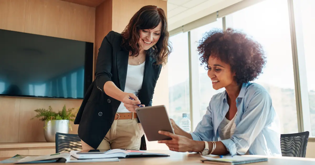 Two business partners discussing a sample operating agreement for LLC to define roles and responsibilities.