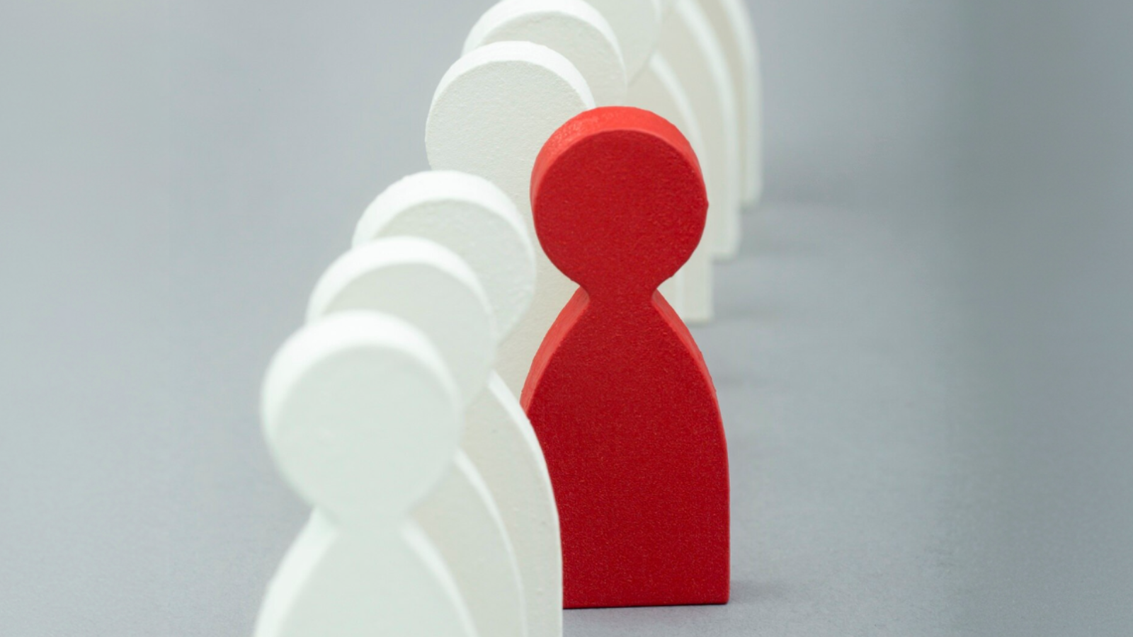 A single red figure standing out among white ones, showing how GreenStar’s digital marketing stands out from the rest.