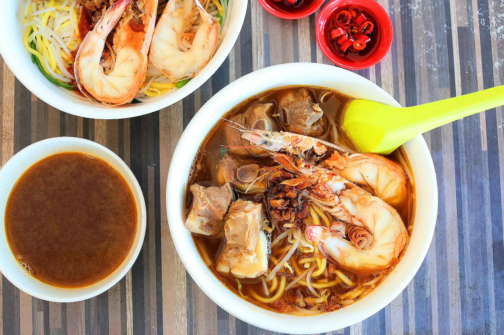 Prawn mee in Singapore with large prawns, pork ribs, noodles, bean sprouts and rich prawn broth