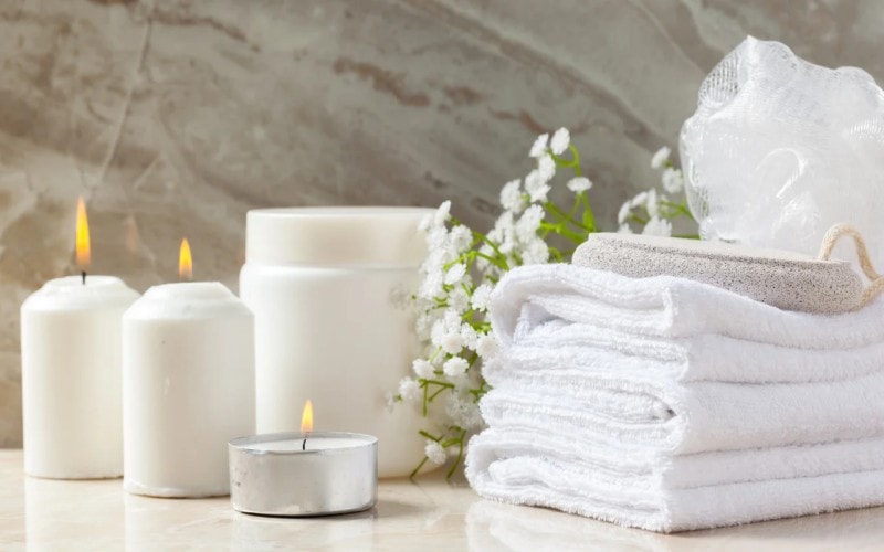 Towels stacked near candles