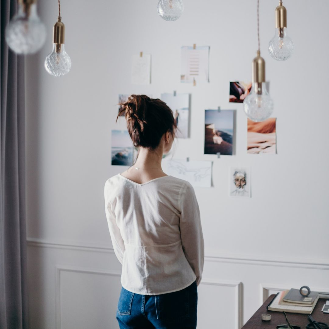 woman looking at images on wall