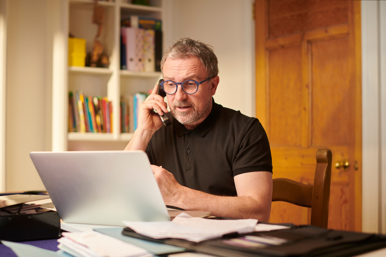 Business owner on phone, speaking with past clients about a broker.