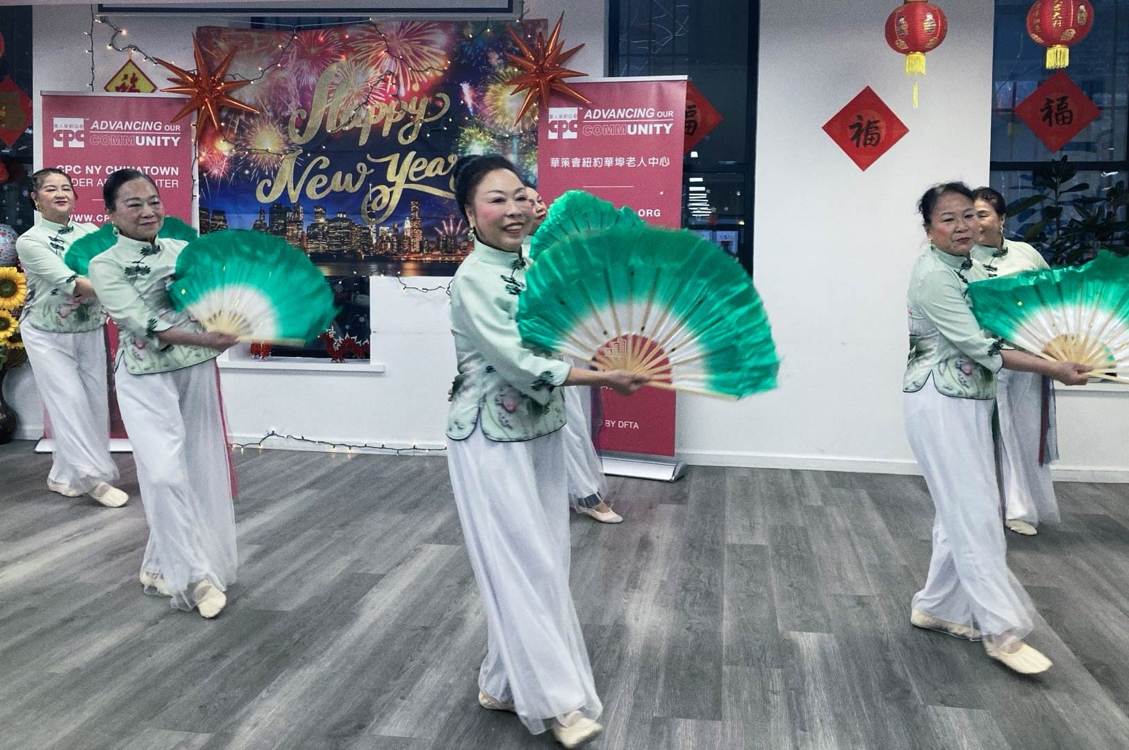 Traditional fan dance performance during a Lunar New Year celebration.