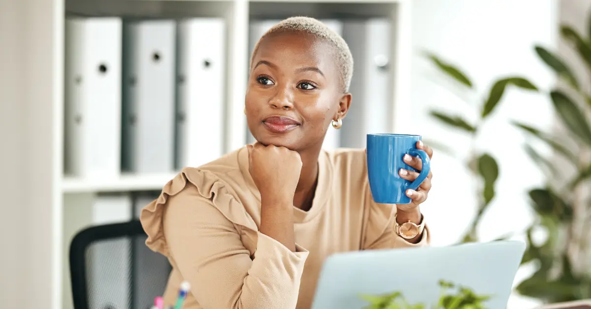 A woman drinking coffee and thinking does Onlyfans count as taxable income?