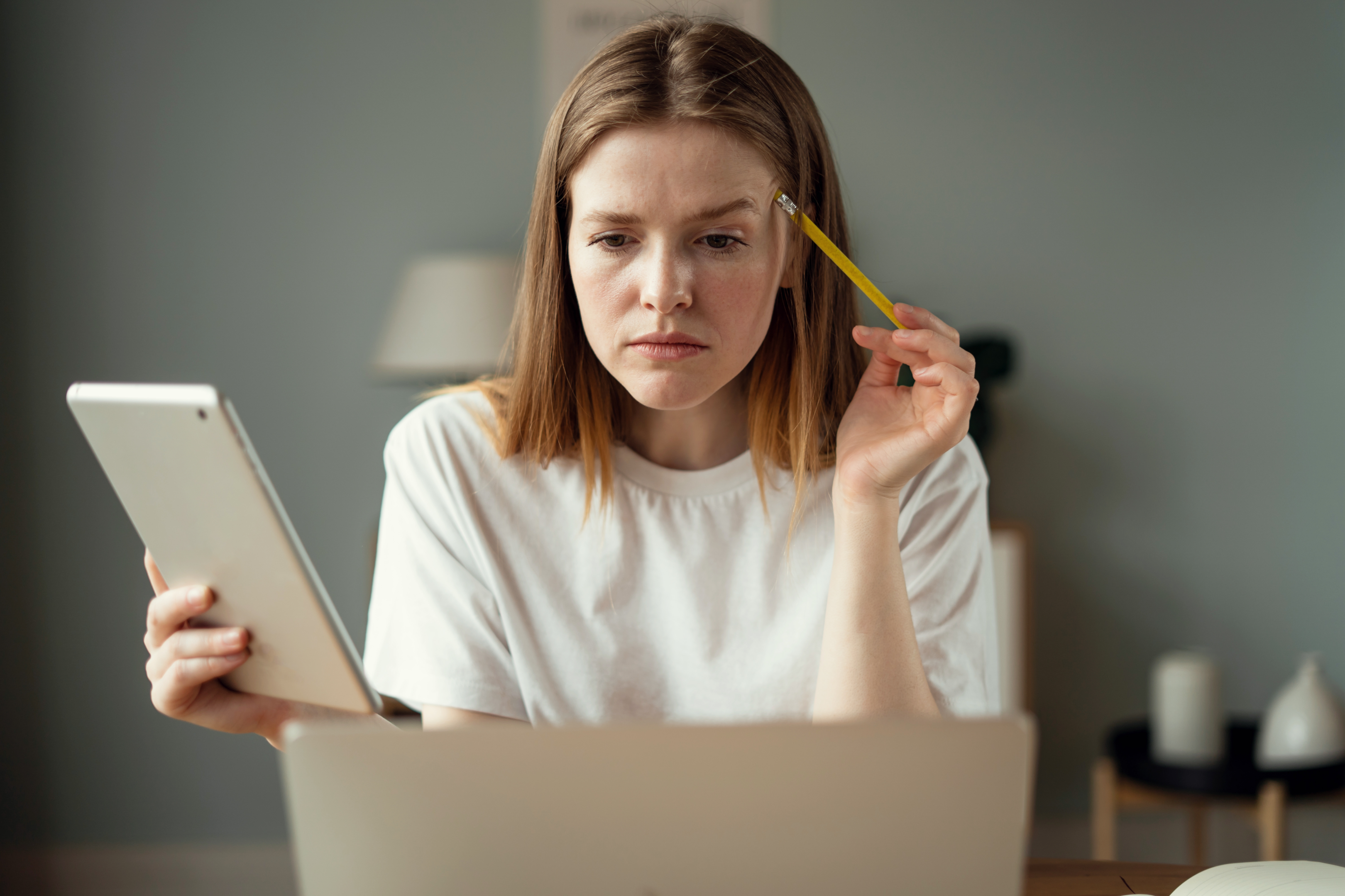 Woman thinking while using laptop