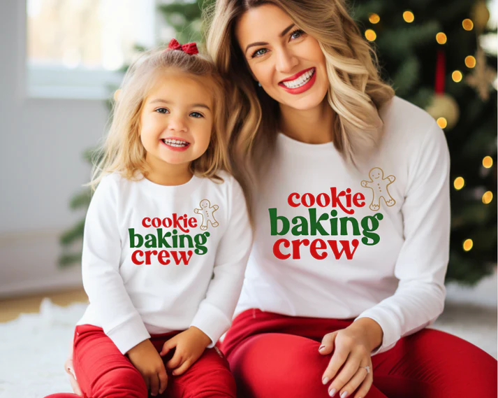 little girl and her adult sister wearing matching sister tees and red pants