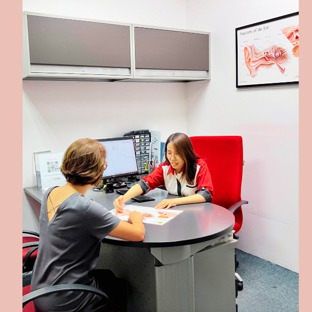 Clarisound hearing care professional explaining hearing assessment results and rehabilitation options to a customer during a consultation at a hearing care centre in Malaysia