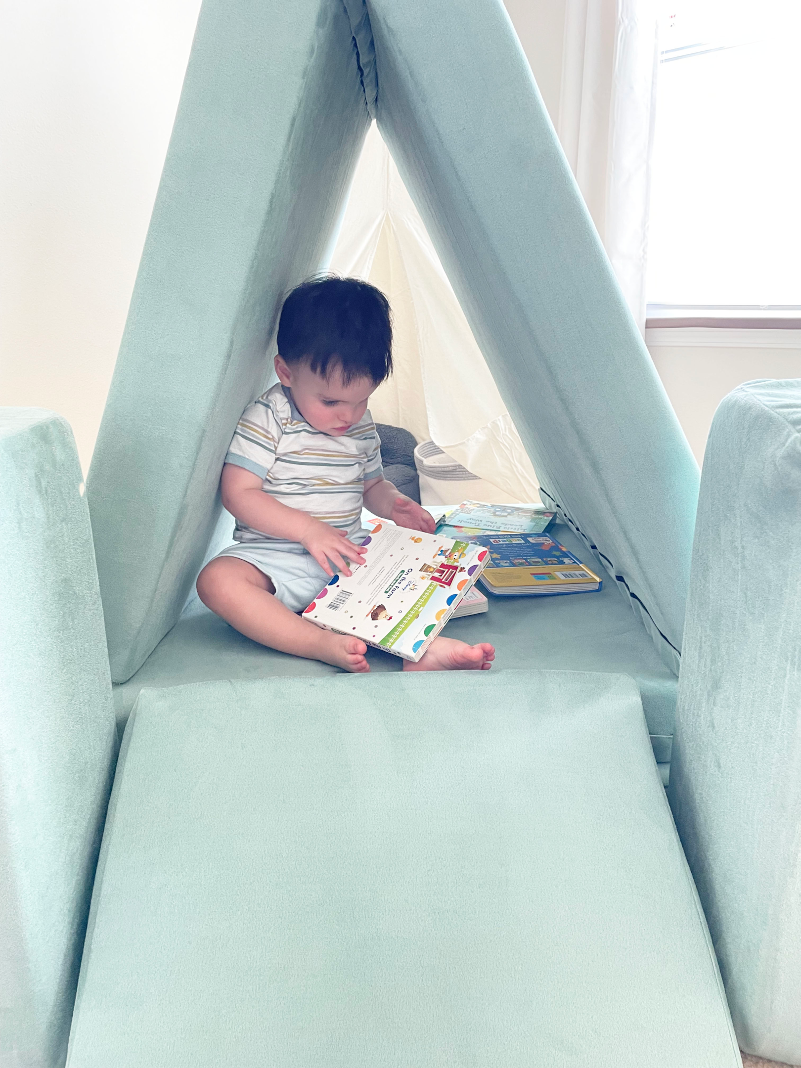 Kid reading in a Figgy tent