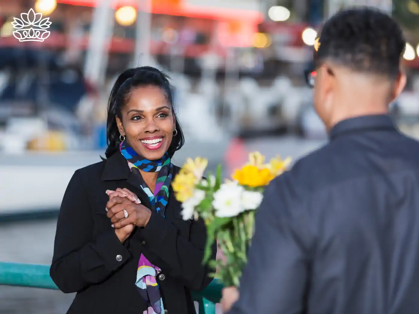 Woman joyfully reacting to a flower bouquet given by a man at a marina. Fabulous Flowers and Gifts, Luxury Flower Arrangements.