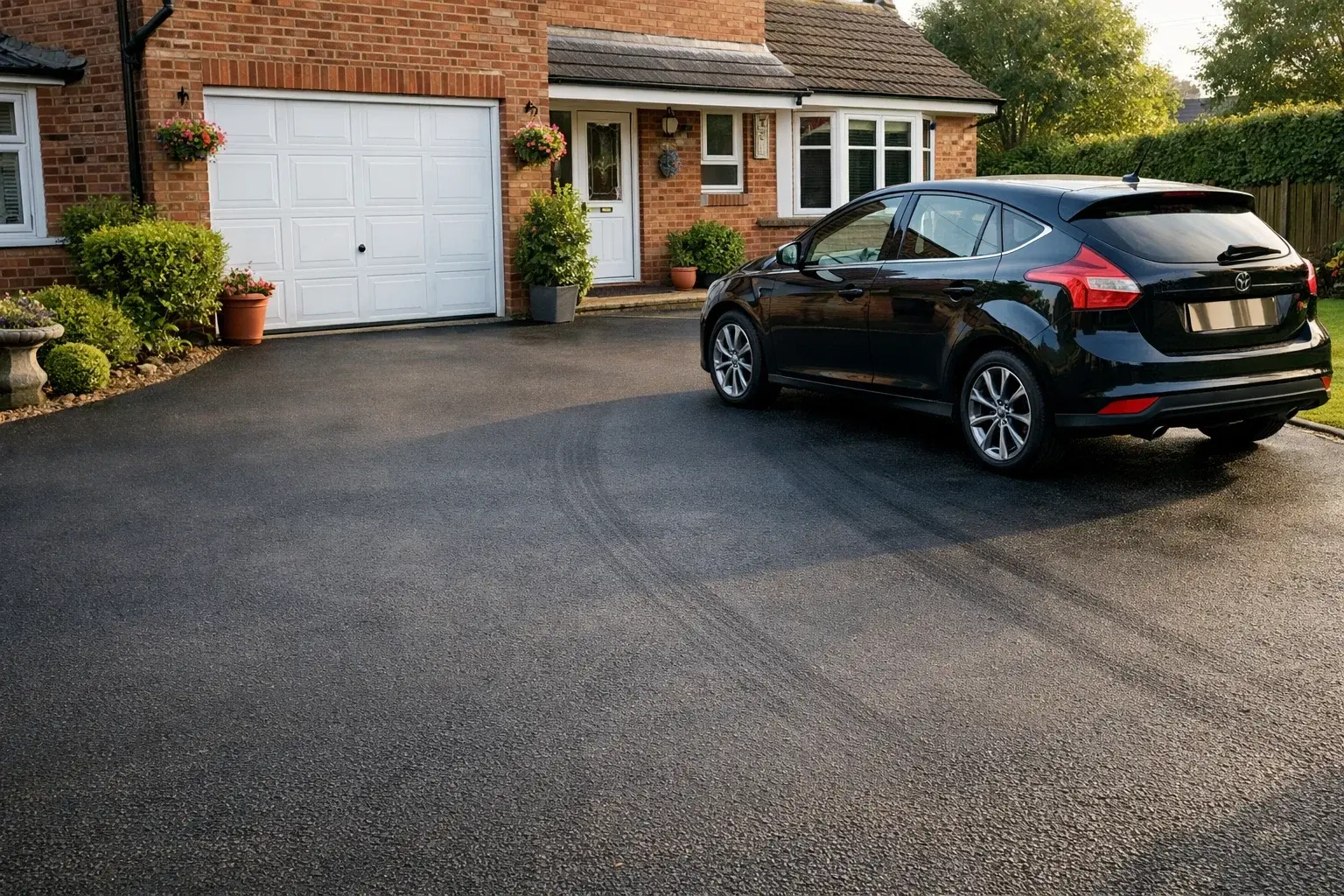 Well-maintained resurfaced driveway showing long-lasting smooth surface in residential setting