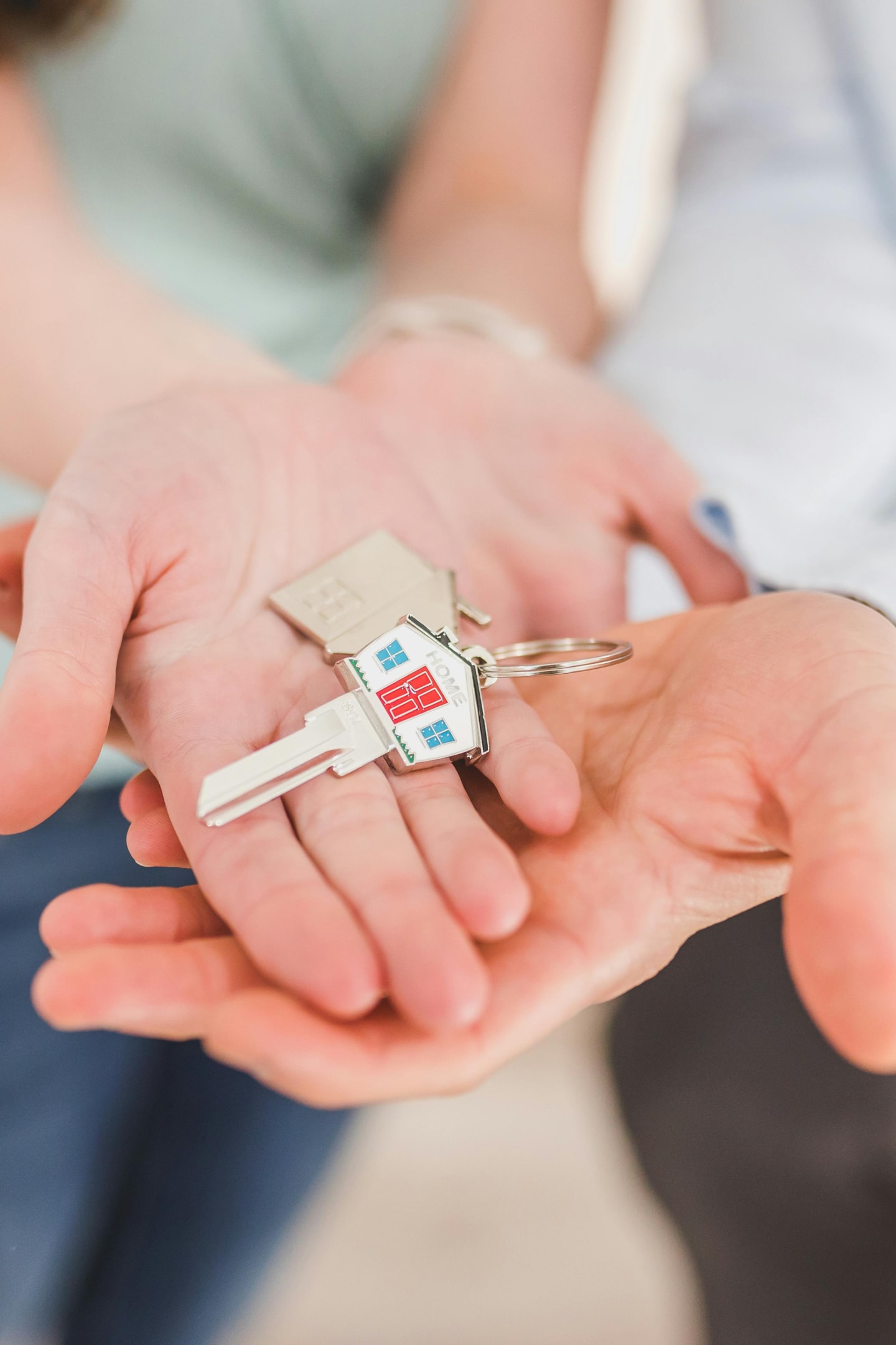 Keys being passed to real estate investor after purchase of property through an assumable mortgage.