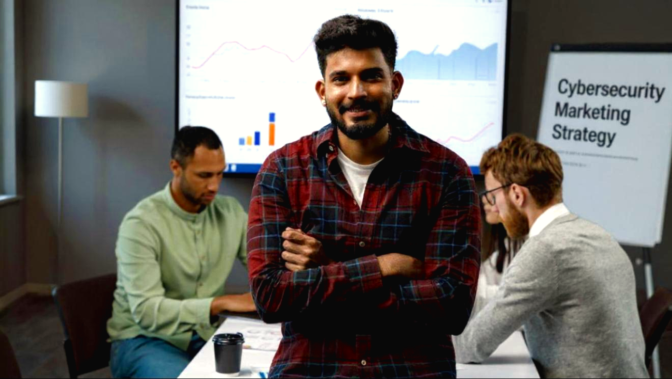 smiling man with team strategizing cybersecurity content marketing, social media management and lead generation