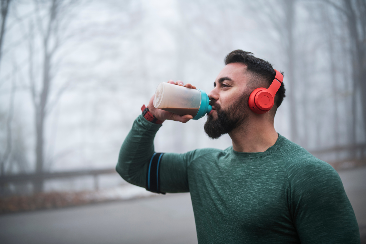 A runner drinking a recovery drink after a long run.