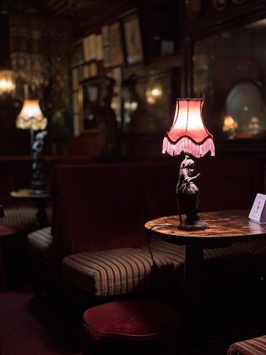 Vintage lights oozing elegance on dimly lit tables at a restaurant that doesn't accept reservations for service