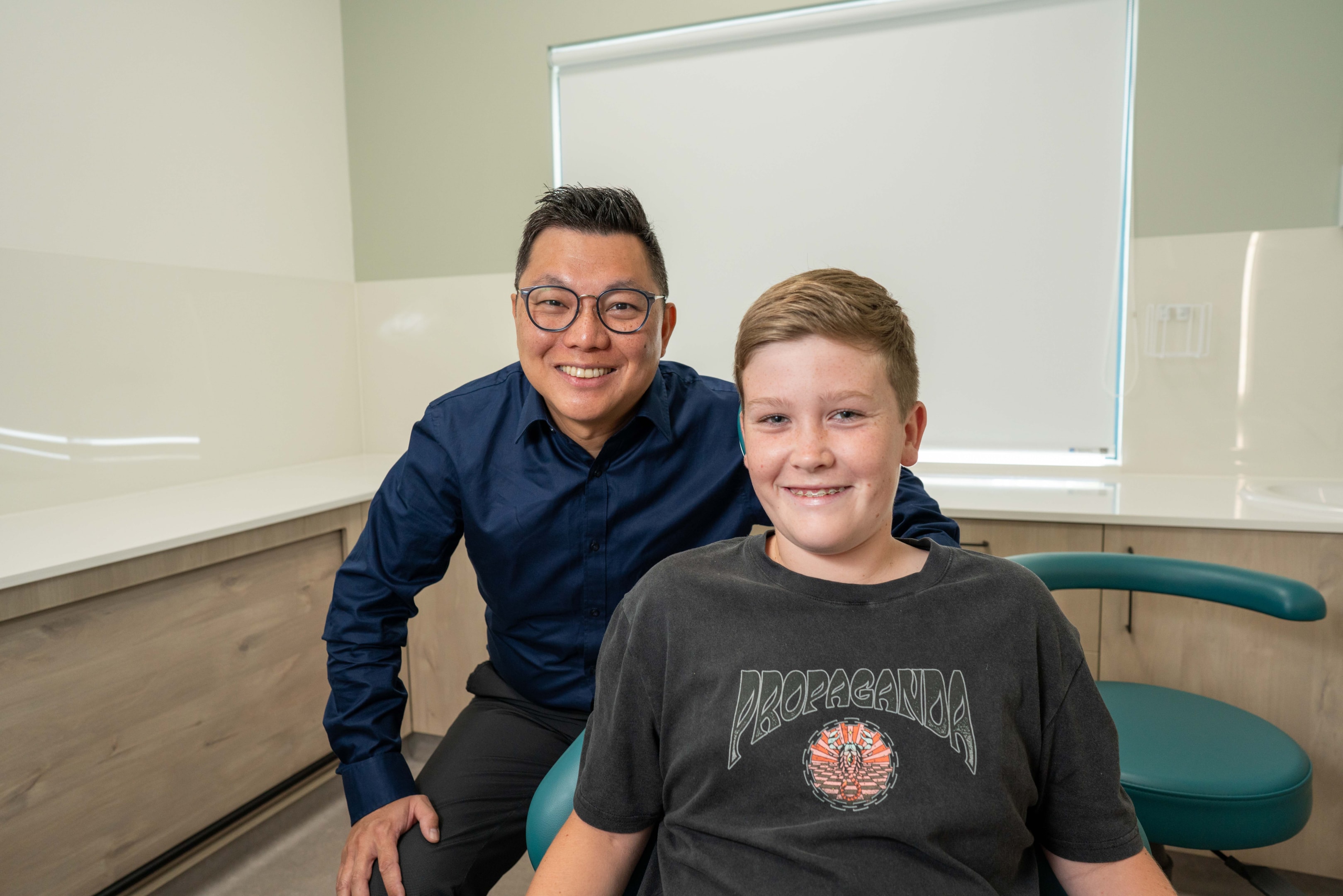 Smile Team orthodontist with patient, a teenage boy wearing braces