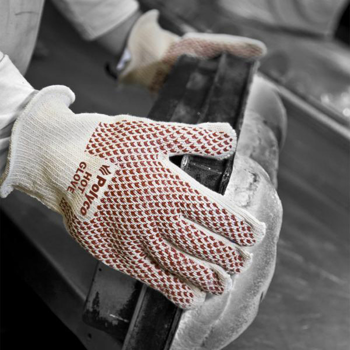 Hands wearing heat-resistant gloves handling hot equipment