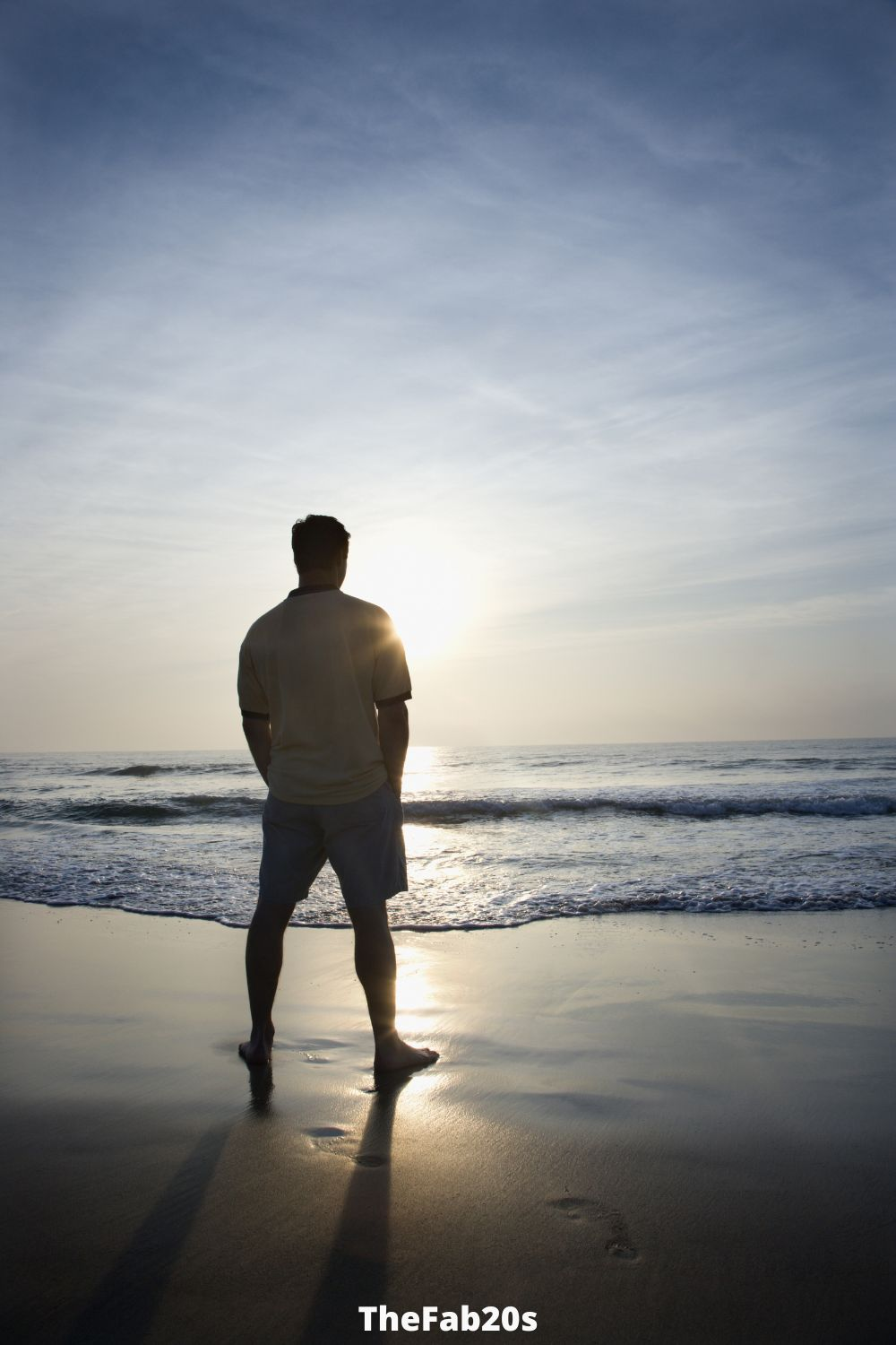 Man looking at sunset on the beach